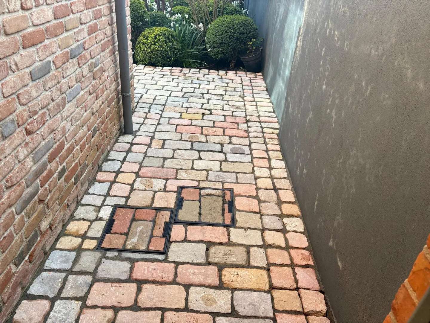 Cobbled side passage pressure washed by Costello Cleaning Services